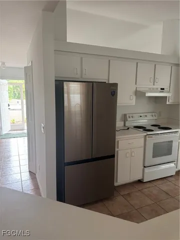 a kitchen with a refrigerator and a stove