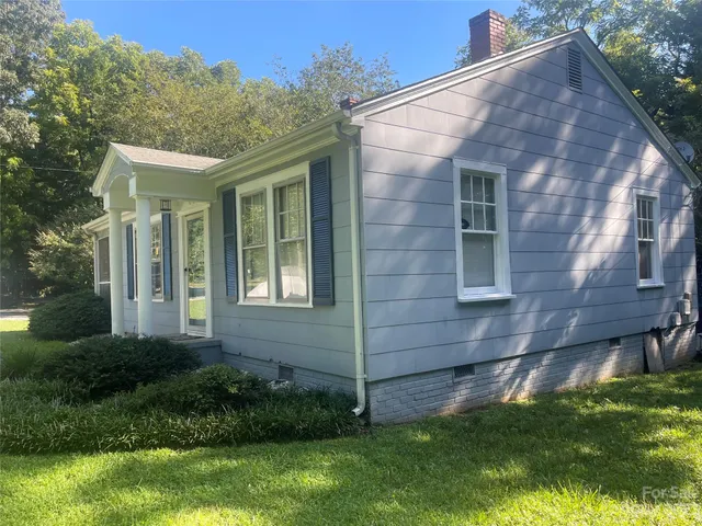 a view of house with backyard