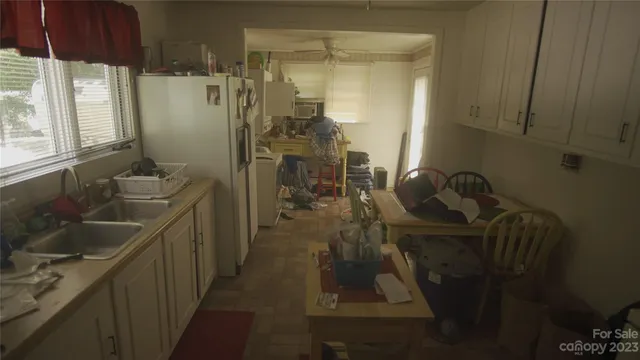 a bathroom with a sink mirror and shower