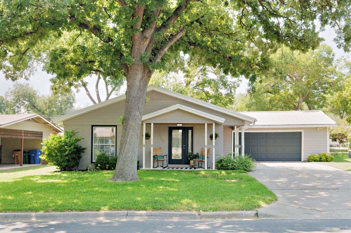 1601 Northridge Drive Austin, TX 78723 - Photo 2 of 40 a front view of a house with a yard and garage