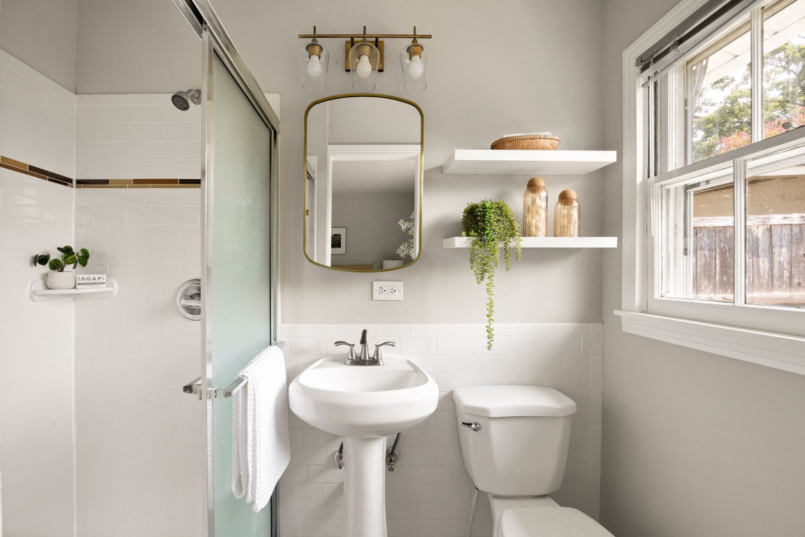 1601 Northridge Drive Austin, TX 78723 - Photo 28 of 40 a bathroom with a toilet sink and mirror