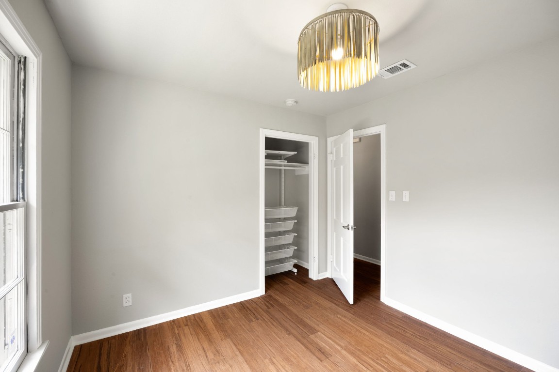 1601 Northridge Drive Austin, TX 78723 - Photo 30 of 40 an empty room with wooden floor cabinet and windows