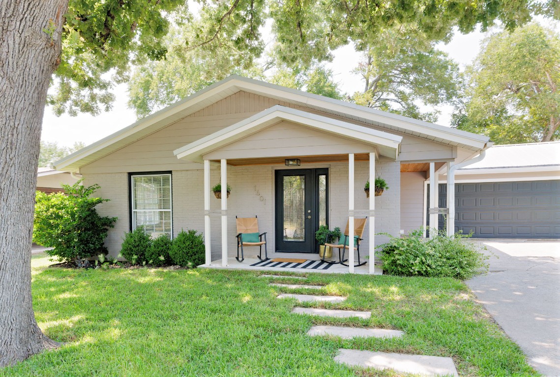1601 Northridge Drive Austin, TX 78723 - Photo 3 of 40 a view of a brick house with a yard potted plants and a large tree