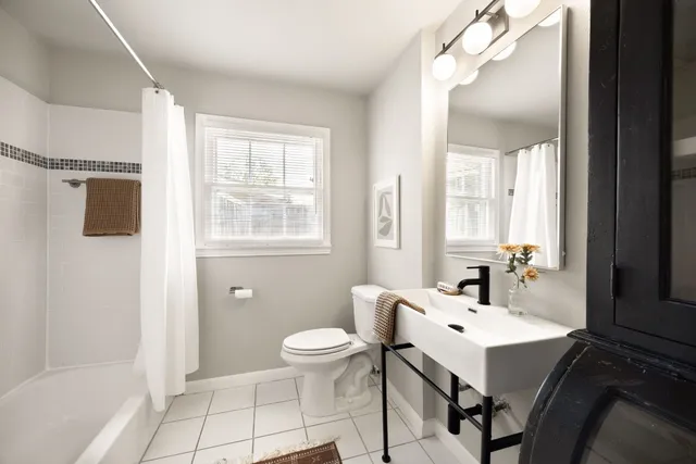 a bathroom with a sink a toilet and mirror