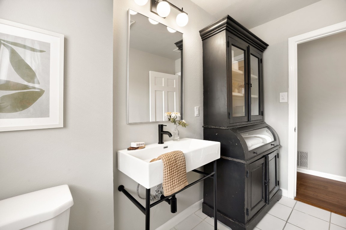 1601 Northridge Drive Austin, TX 78723 - Photo 32 of 40 a bathroom with a sink a toilet and mirror