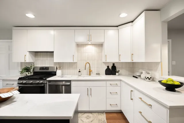 a kitchen with a sink a stove and cabinets