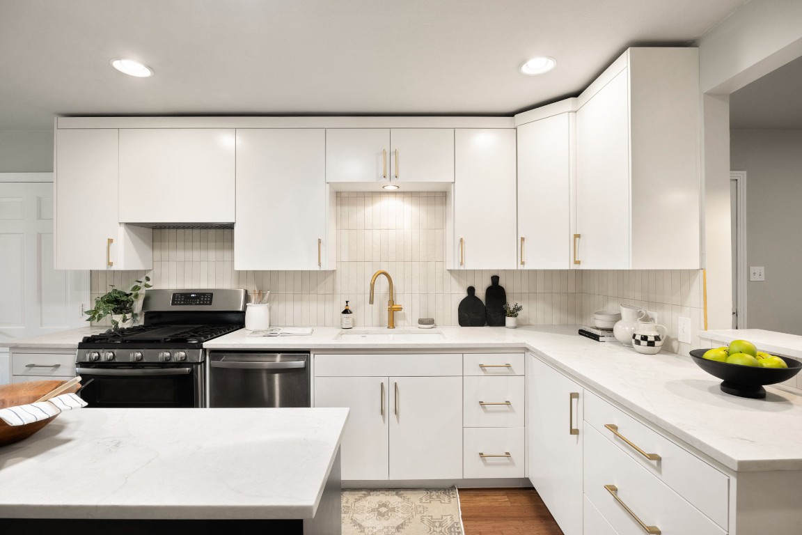1601 Northridge Drive Austin, TX 78723 - Photo 5 of 40 a kitchen with a sink a stove and cabinets