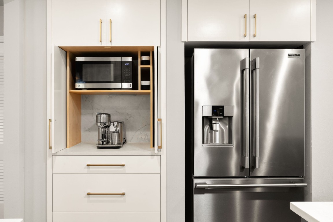 1601 Northridge Drive Austin, TX 78723 - Photo 9 of 40 a kitchen with a refrigerator and cabinets