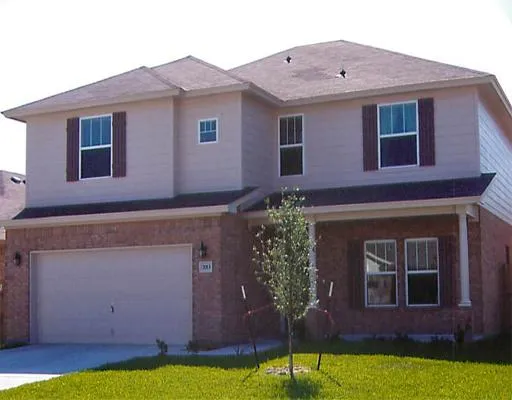 a brick house with a yard in front of it