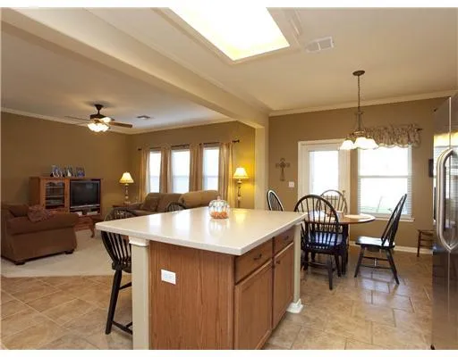 a kitchen with granite countertop a sink stove and refrigerator