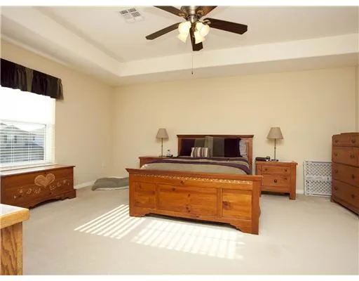 a bedroom with a bed a dresser and a book shelf