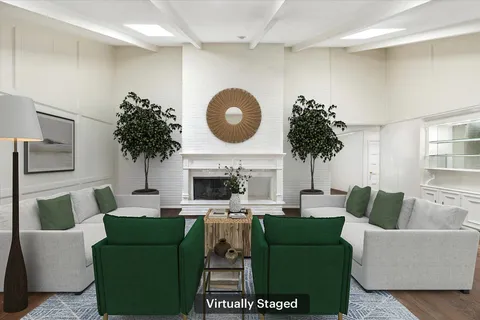 a living room with furniture a fireplace and a wooden floor