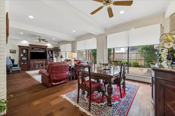 a living room with furniture a flat screen tv and a large window