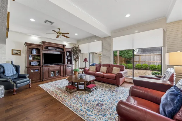 a living room with furniture fireplace and a large window