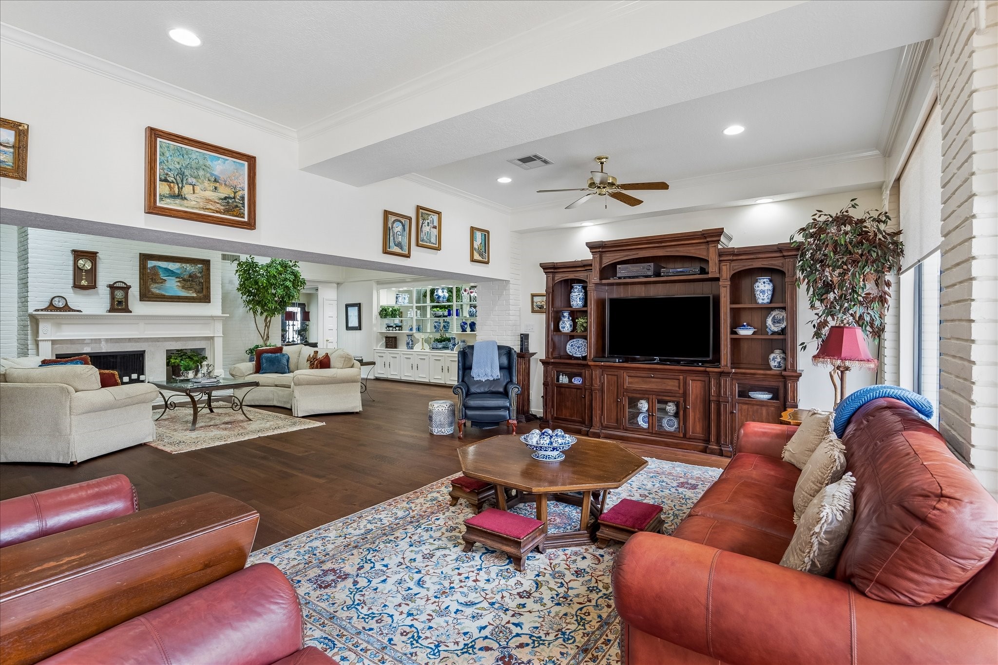 13503 Myrtlea Drive Houston, TX 77079 - Photo 22 of 50 a living room with furniture a flat screen tv and a fireplace
