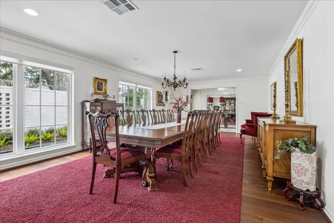 a dining room with furniture and wooden floor