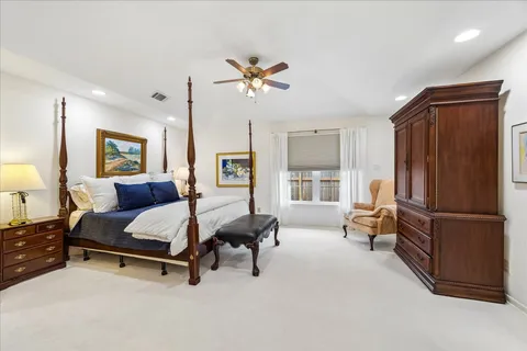 a bedroom with furniture and a chandelier