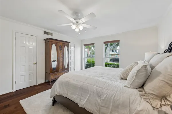 a bedroom with a bed chairs and window