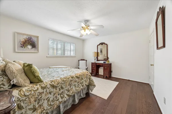 a bedroom with a bed chairs and window