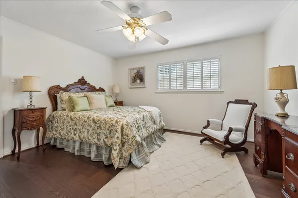 a bedroom with a bed a couch and dresser