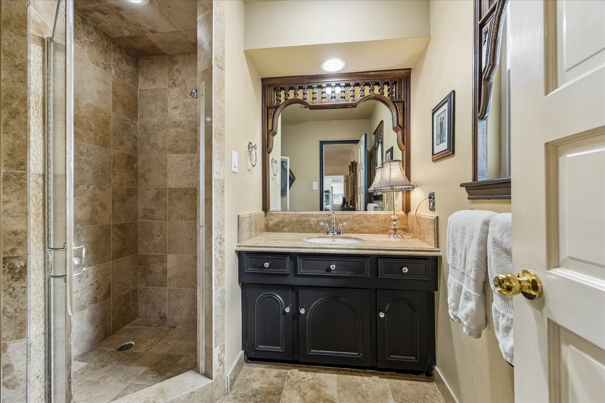 13503 Myrtlea Drive Houston, TX 77079 - Photo 41 of 50 a bathroom with a granite countertop sink a mirror and a shower