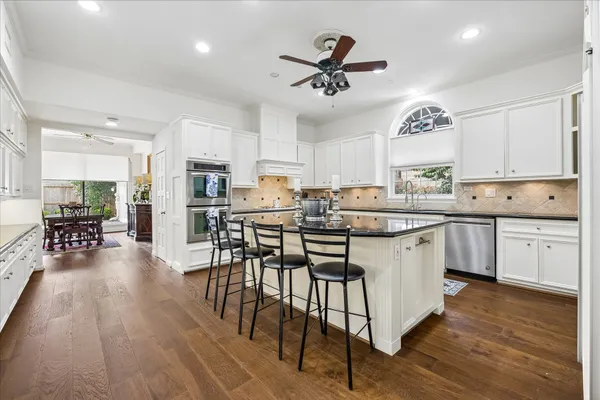 a kitchen with granite countertop a sink and stainless steel appliances