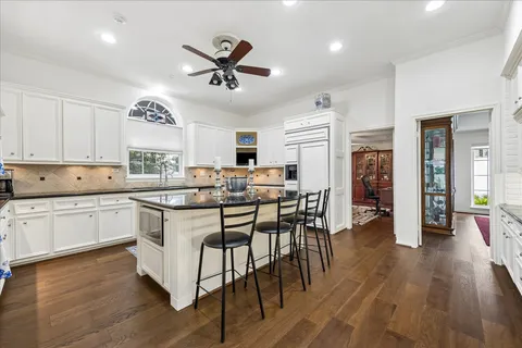a kitchen with counter top space and wooden floor