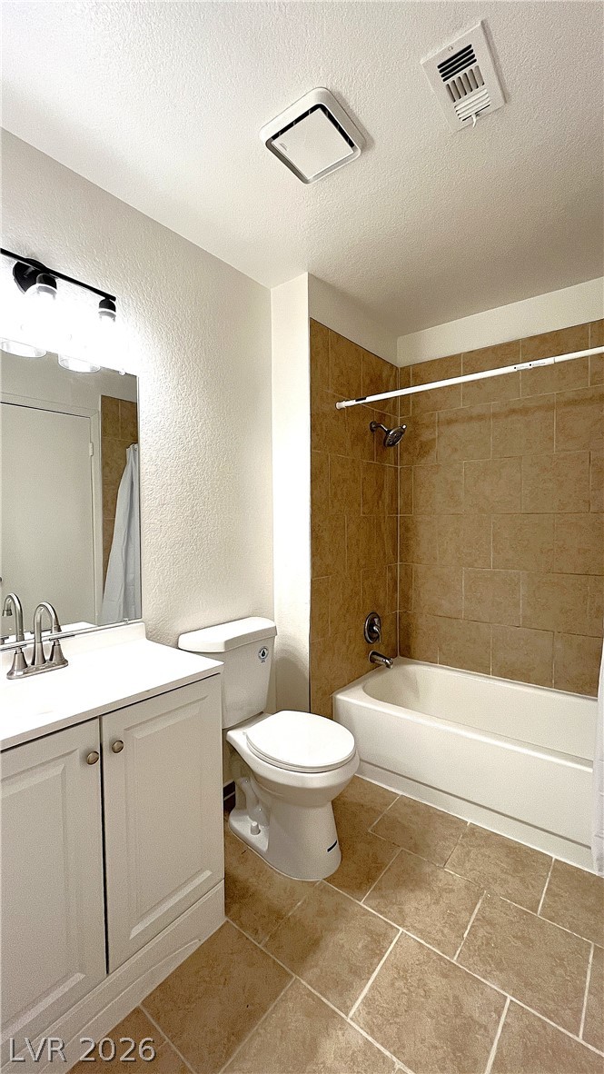 6750 Del Rey Avenue, Unit 123 Las Vegas, NV 89146 - Photo 15 of 21 Well-appointed bath featuring a tiled shower, a classic vanity, and practical floor tiling.