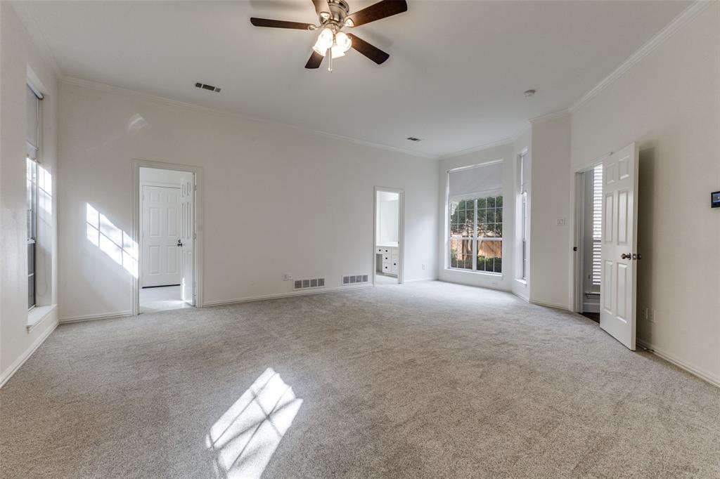 17101 Vista Tree Circle Dallas, TX 75248 - Photo 11 of 22 a view of a livingroom with a ceiling fan and window