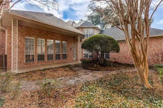 a backyard of a house with table and chairs