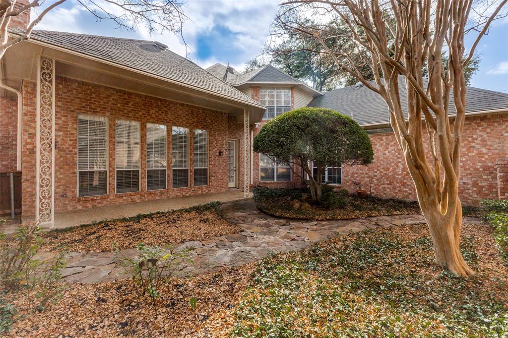 17101 Vista Tree Circle Dallas, TX 75248 - Photo 2 of 22 a backyard of a house with table and chairs