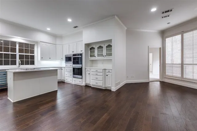 a kitchen with stainless steel appliances a stove sink microwave and cabinets