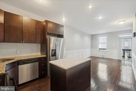 a kitchen with stainless steel appliances a refrigerator and a stove