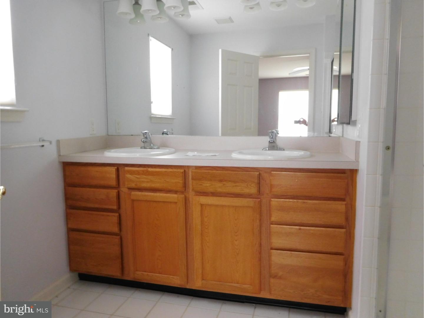 129 Somerfield Road Swedesboro, NJ 08085 - Photo 5 of 7 a bathroom with a sink and a mirror