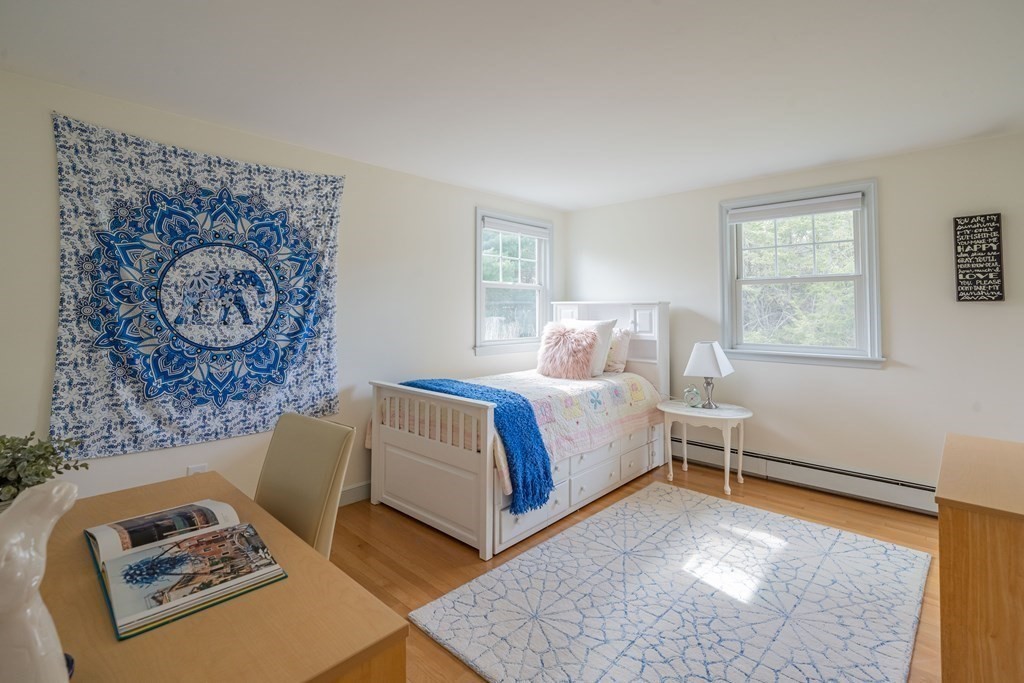 35 Saddle Club Road Lexington, MA 02420 - Photo 33 of 42 a bedroom with a bed lamp and a window