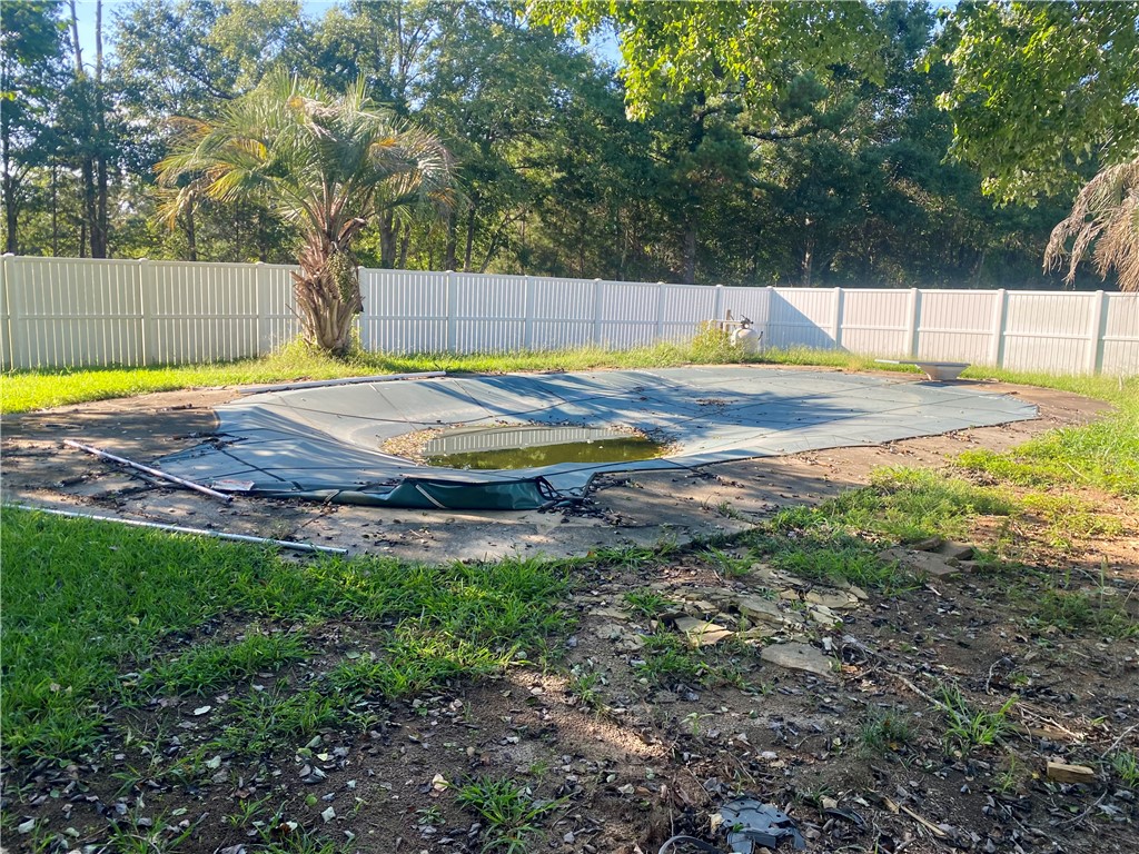 327 Five Forks Road Anderson, SC 29621 - Photo 10 of 31 A spacious backyard features an in-ground pool enclosed by privacy fencing.