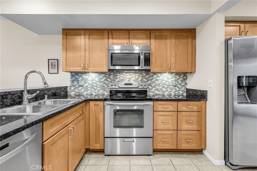 2252 El Capitan Drive Riverside, CA 92506 - Photo 20 of 51 a kitchen with stainless steel appliances granite countertop a sink stove and refrigerator