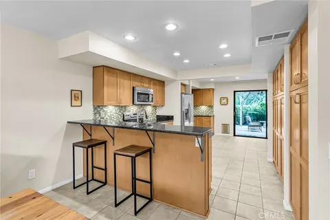 a kitchen with stainless steel appliances granite countertop a refrigerator and microwave