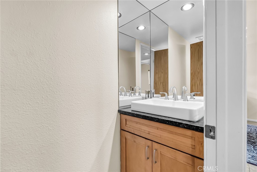 2252 El Capitan Drive Riverside, CA 92506 - Photo 26 of 51 a bathroom with a sink and a mirror