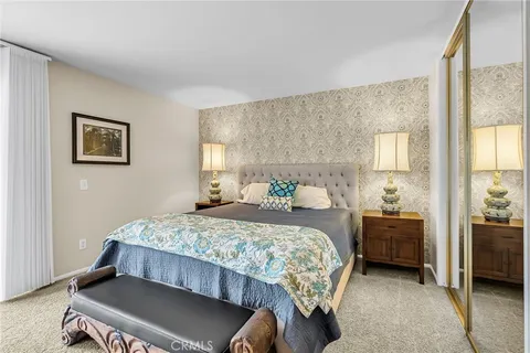 a bedroom with a bed and a television