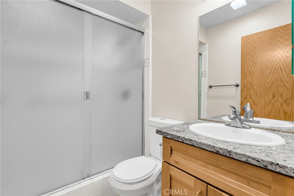 2252 El Capitan Drive Riverside, CA 92506 - Photo 37 of 51 a bathroom with a granite countertop sink toilet and shower