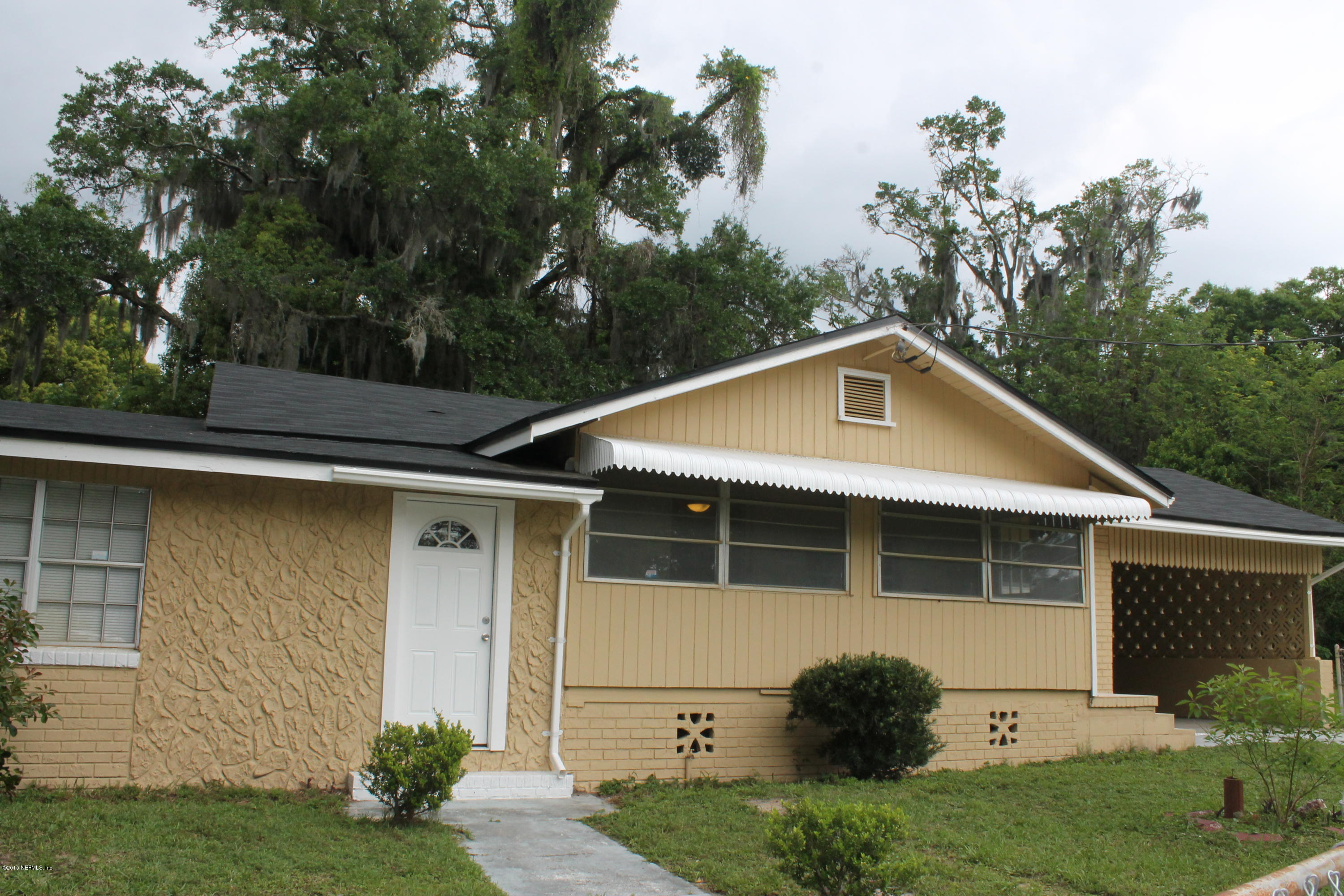 6207 Lone Star Road Jacksonville, FL 32211 - Photo 1 of 35 a front view of a house with garden