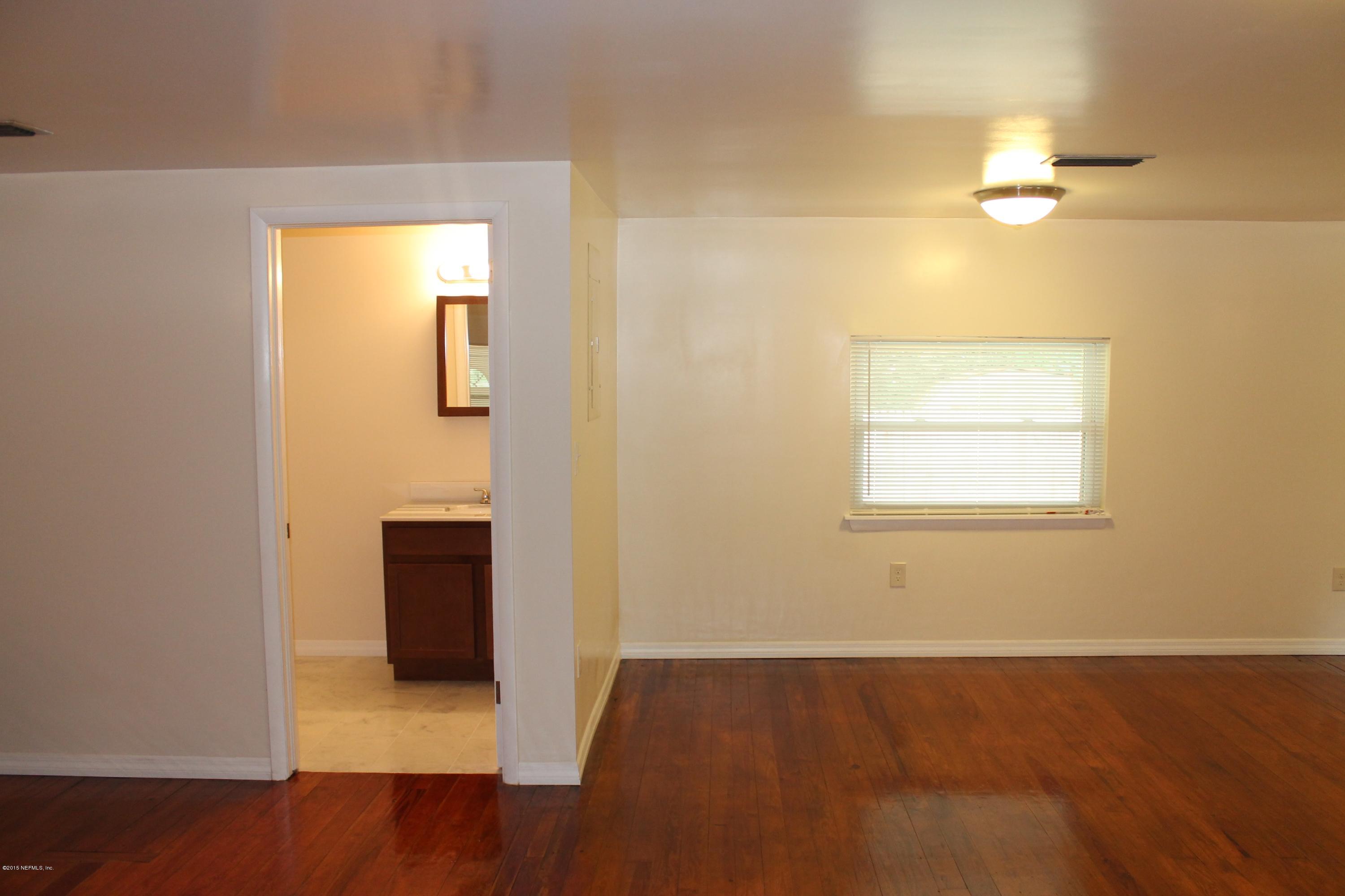 6207 Lone Star Road Jacksonville, FL 32211 - Photo 12 of 35 an empty room with wooden floor and windows