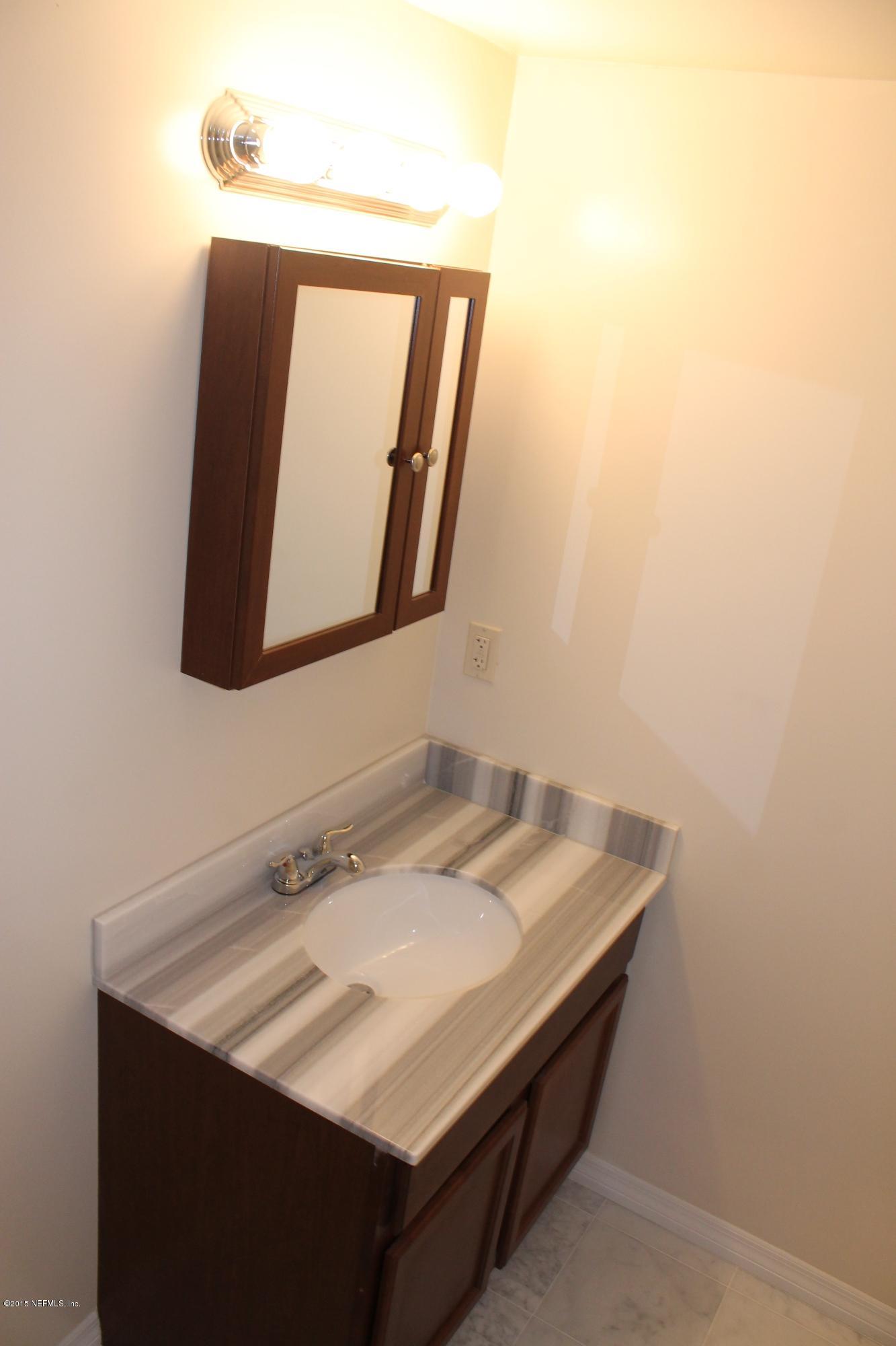 6207 Lone Star Road Jacksonville, FL 32211 - Photo 13 of 35 a bathroom with a sink vanity and a mirror
