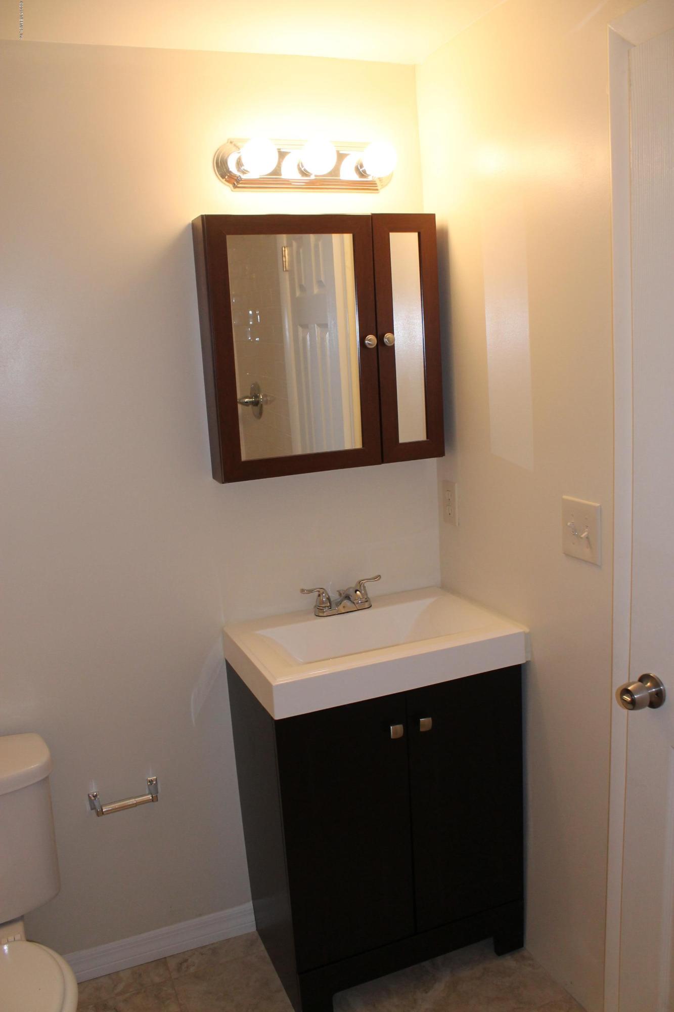 6207 Lone Star Road Jacksonville, FL 32211 - Photo 25 of 35 a bathroom with a sink and a mirror