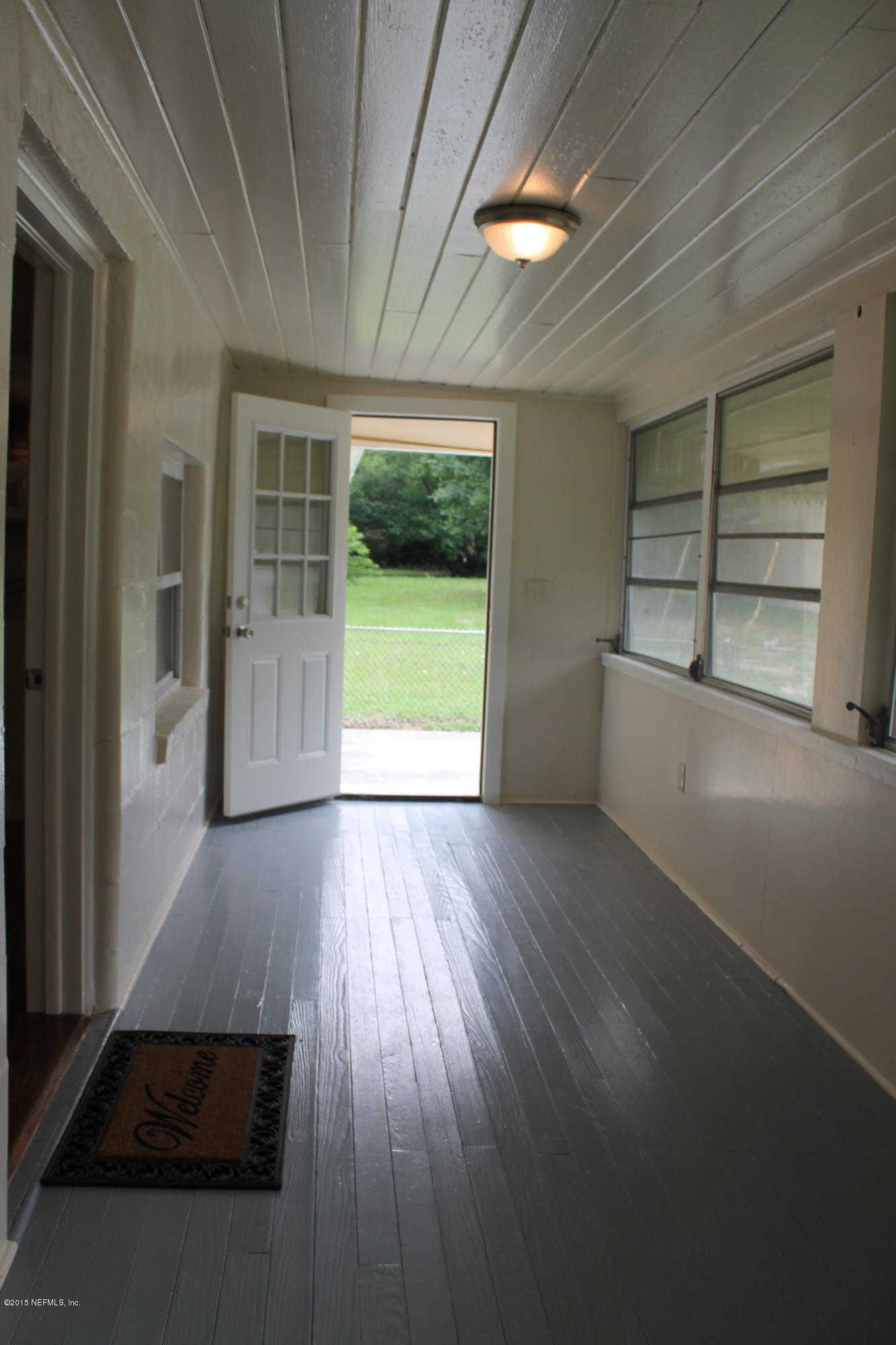 6207 Lone Star Road Jacksonville, FL 32211 - Photo 4 of 35 an empty room with wooden floor and windows