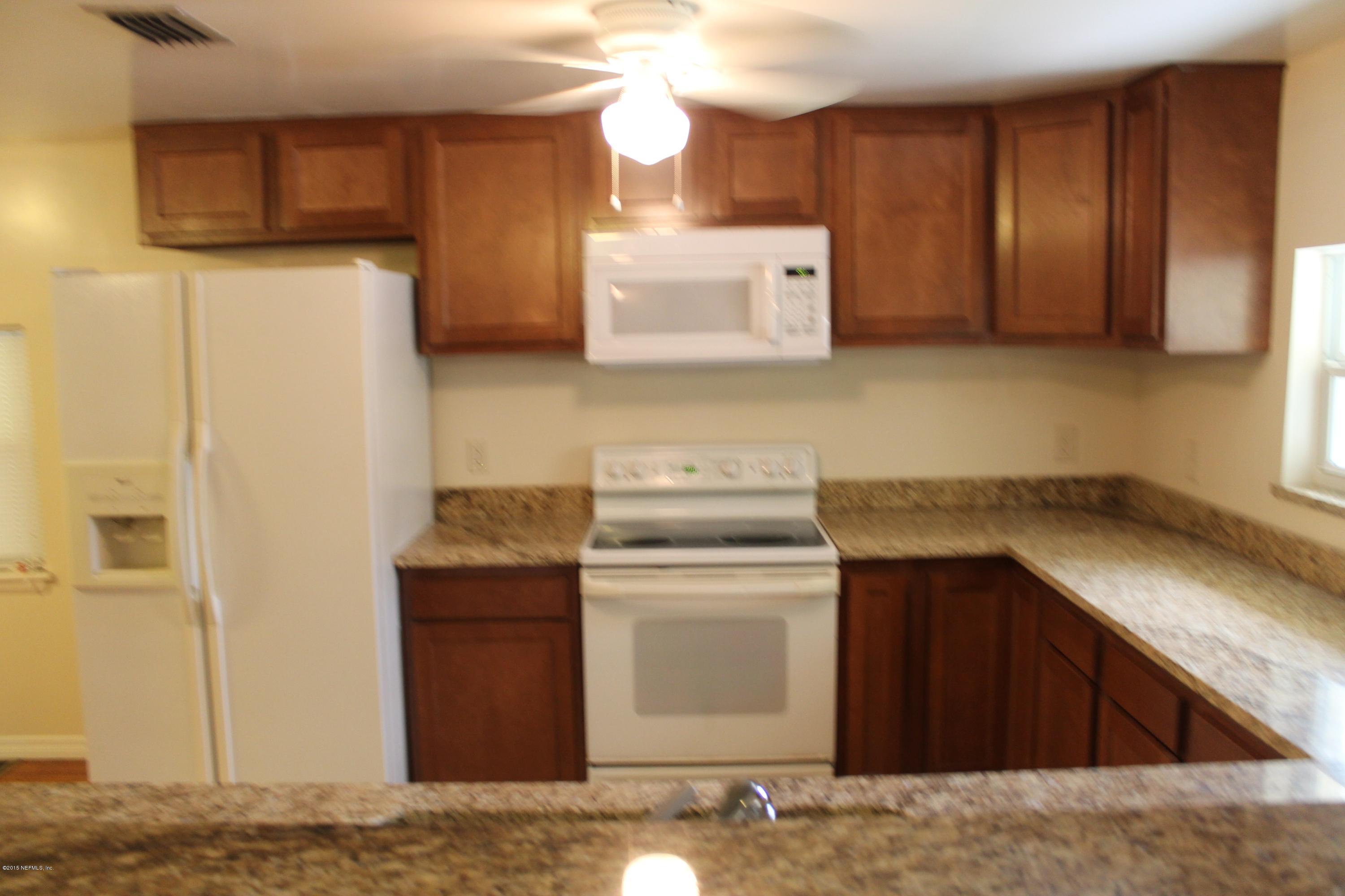 6207 Lone Star Road Jacksonville, FL 32211 - Photo 9 of 35 a kitchen with stainless steel appliances granite countertop a refrigerator and a stove
