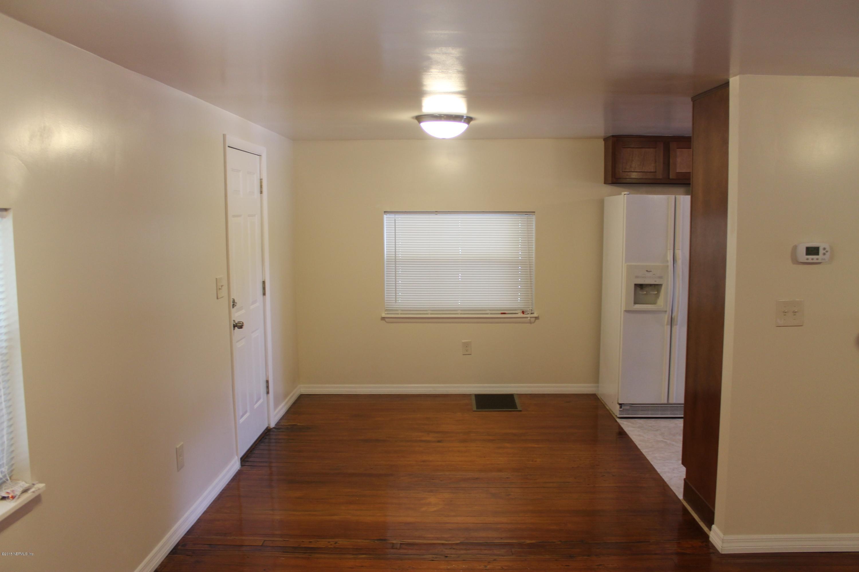 6207 Lone Star Road Jacksonville, FL 32211 - Photo 10 of 35 a view of an empty room with wooden floor and a window