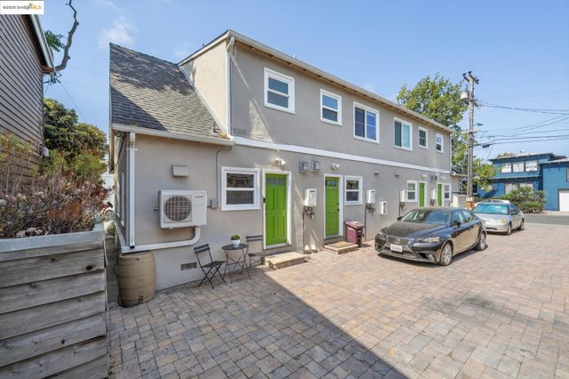 a front view of a house with outdoor seating