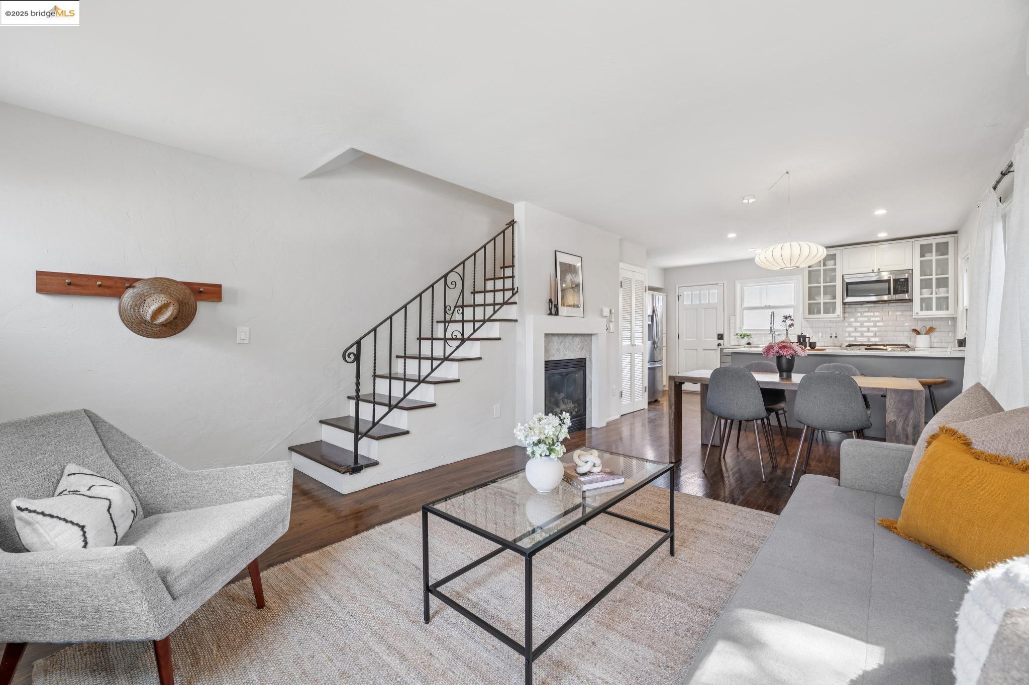 4170 Emerald Street, Unit 4 Oakland, CA 94609 - Photo 7 of 37 Living room with dark wood-style floors, a high end fireplace, recessed lighting, and stairway
